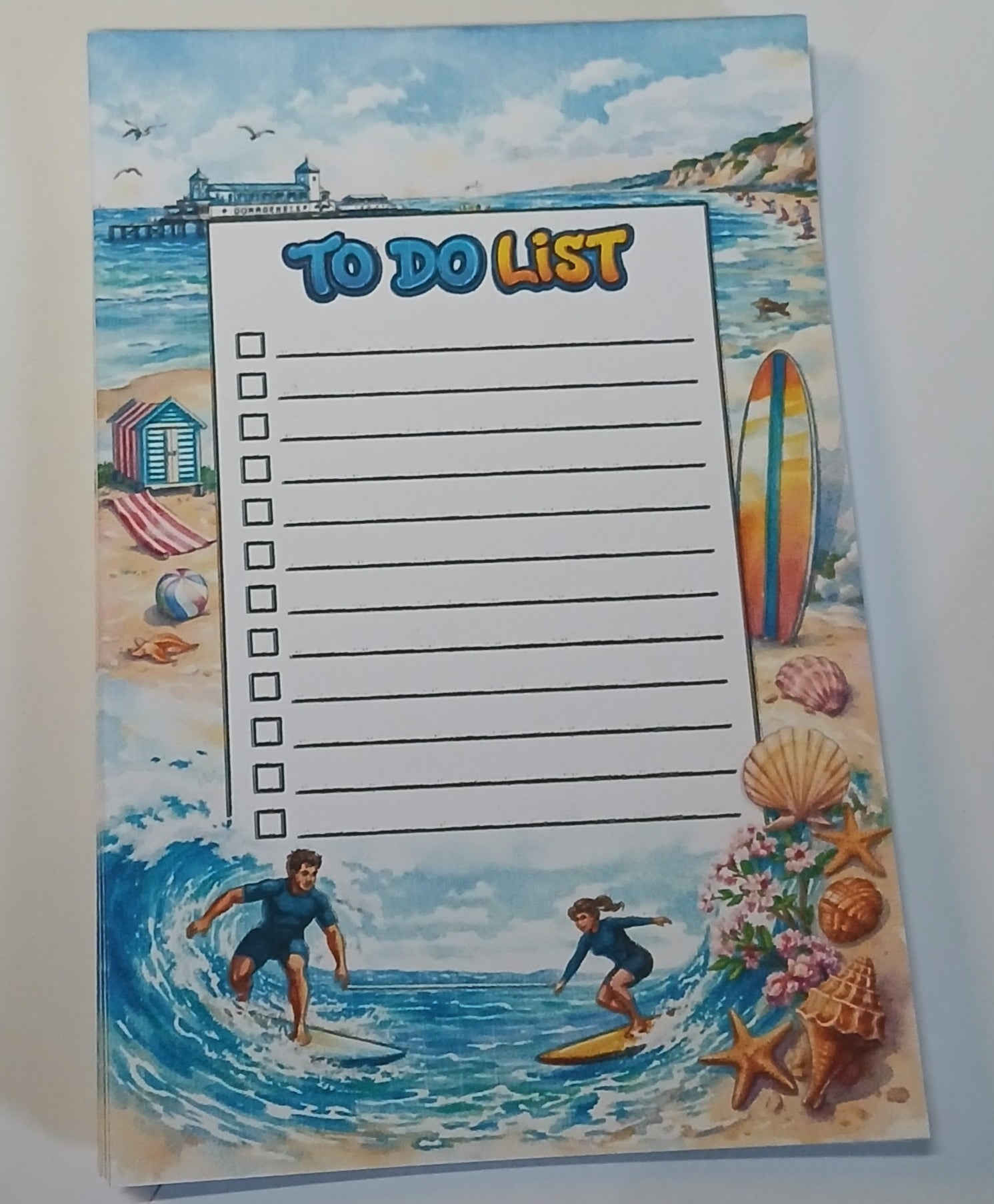 Notebook with a beach scene cover featuring a to-do list.