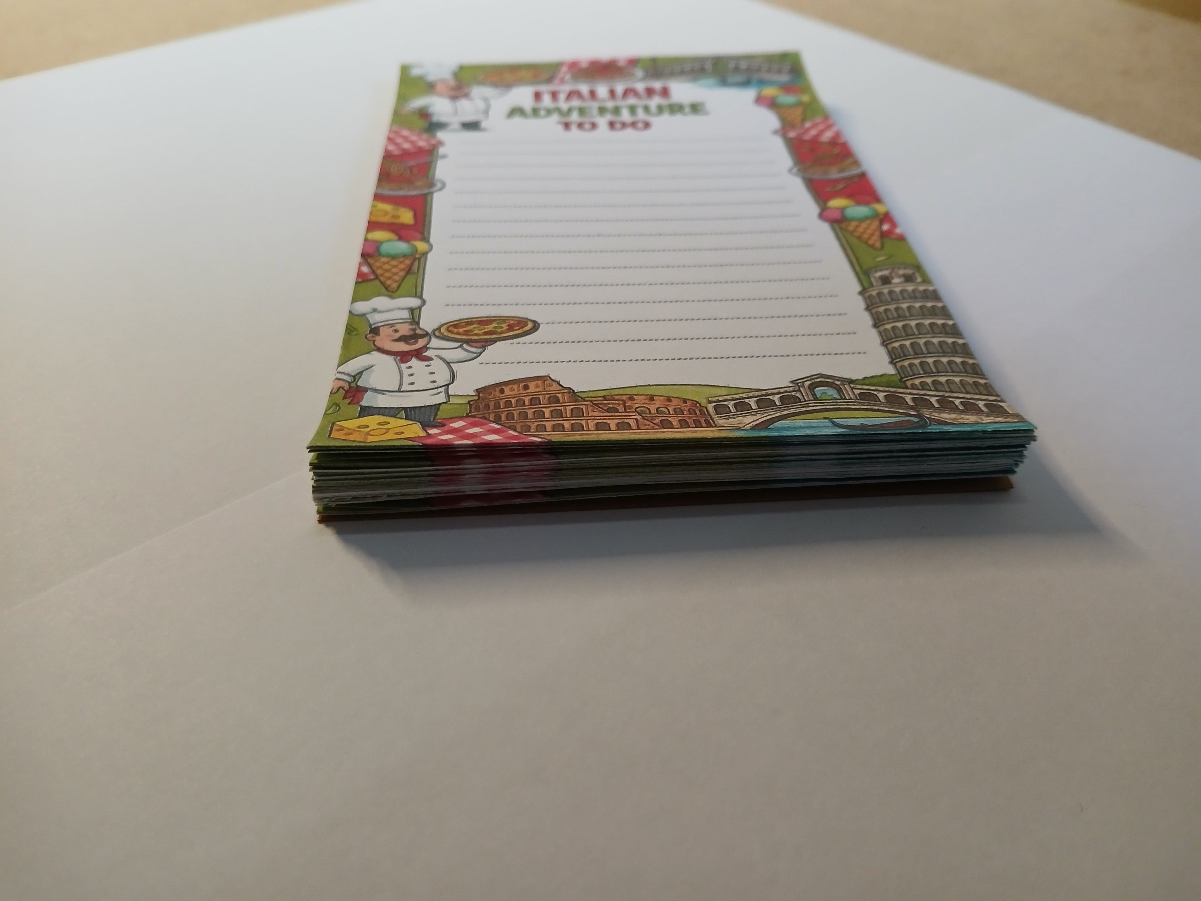 Notepad with Italian-themed design on a white surface