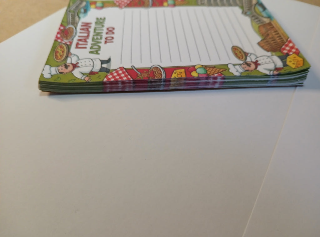 Colorful notepad with Italian-themed design on a white surface